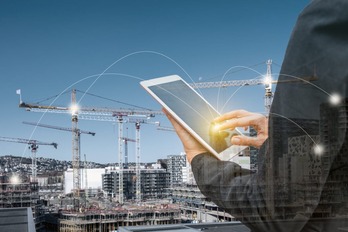 Businesswoman touching tablet with network line on construction